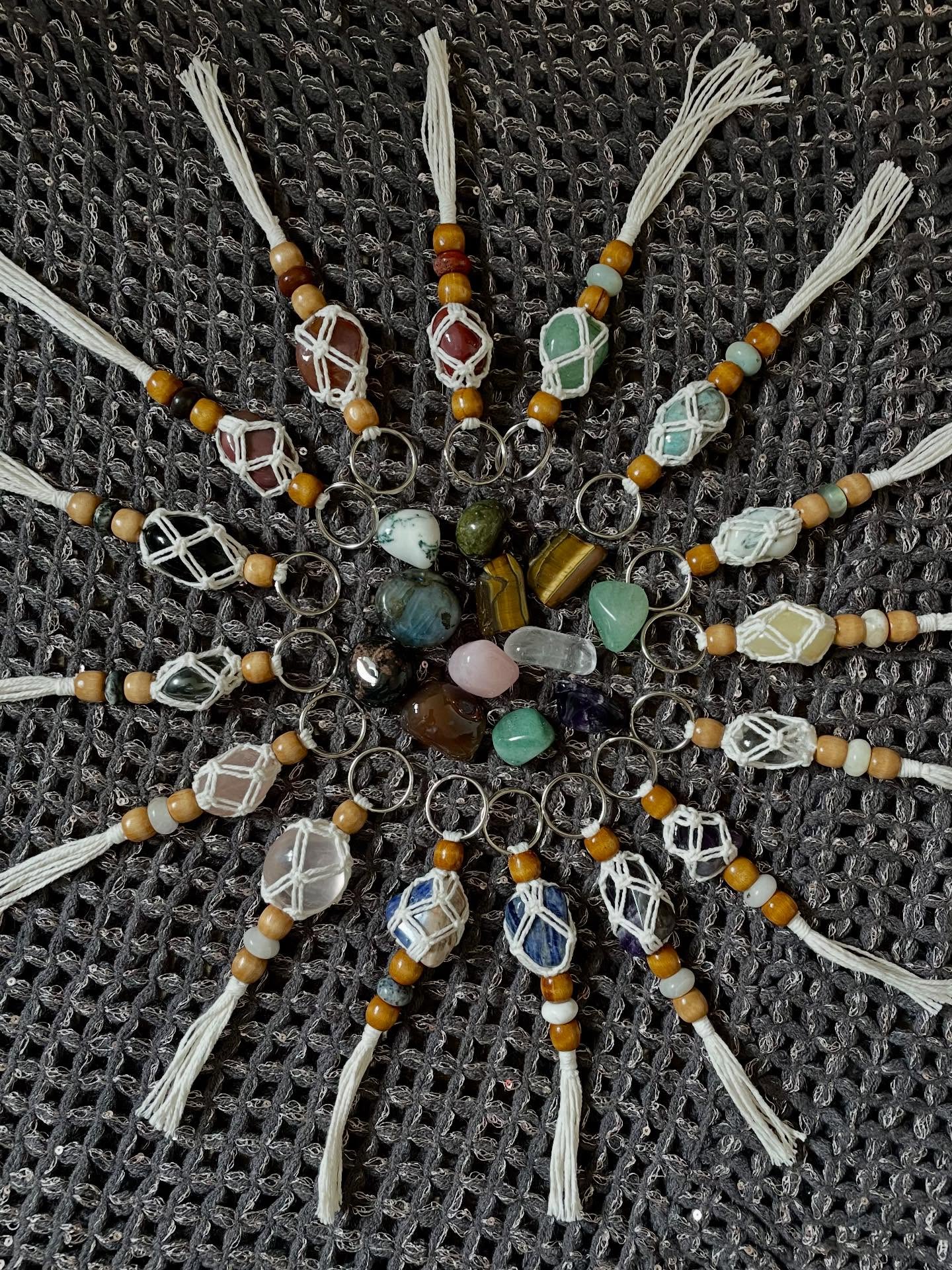 Selection of crystal macrame keyrings laid out in a circle