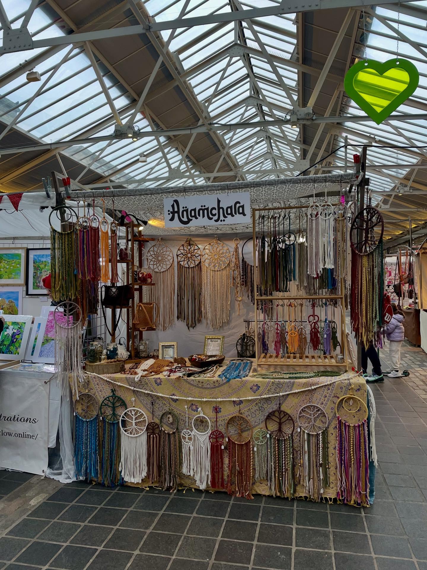 Anamchara market stall filled with handmade macrame pieces and hanging wall work